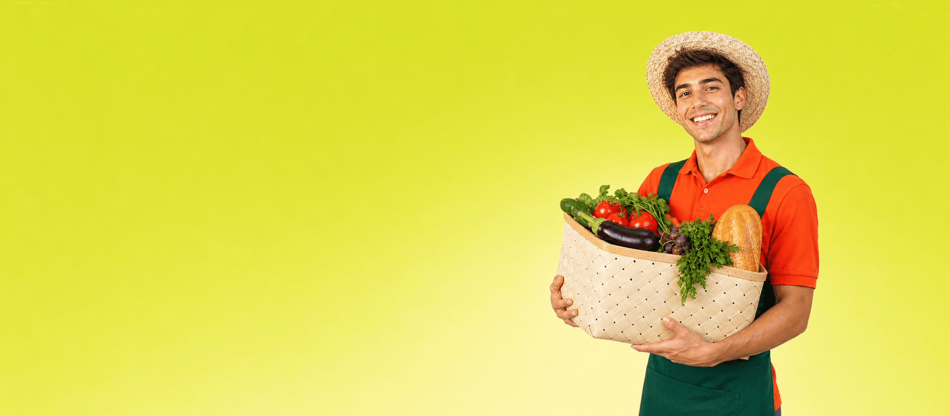 Marché Main team member holding a basket of fresh groceries